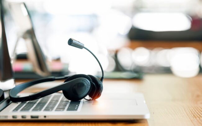 Vantaggi tecnologia voip computer con una cuffia appoggiata sopra